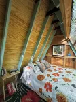 Charming A-frame cabin set in the woods overlooking deep wooded ravines.