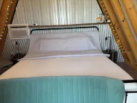 King bed in Tulip Glamping Aframe at Noble Pine Campground