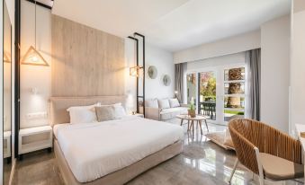 a modern hotel room with a large bed , white bedding , and sliding glass doors leading to a balcony at Minthi Boutique Apartments