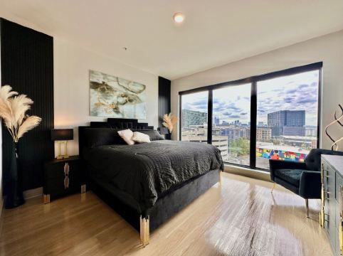 Ceiling to floor windows featuring a private balcony with stunning city views!
