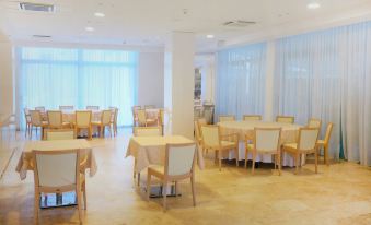 a large dining room with multiple tables and chairs arranged for a group of people to enjoy a meal together at Nautilus