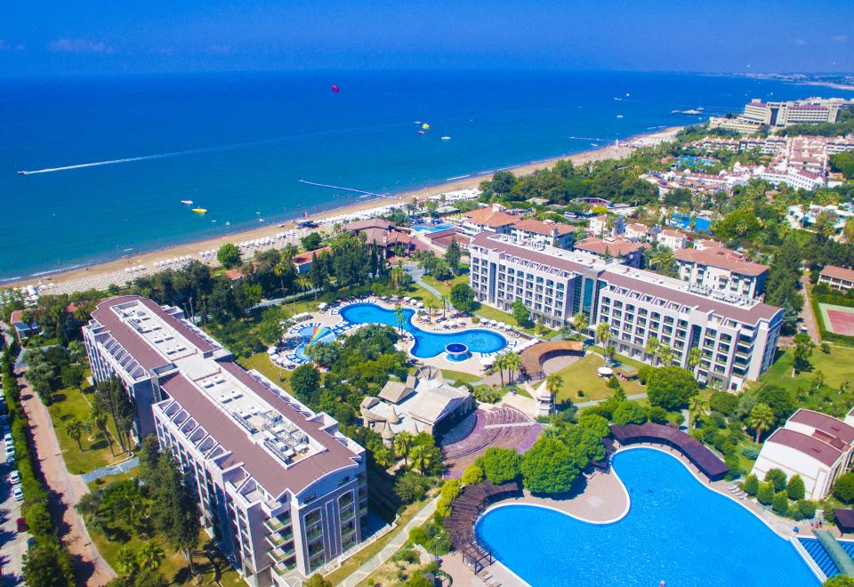 a bird 's eye view of a resort with multiple pools and buildings , set on the beach at Horus Paradise Luxury Resort - All Inclusive