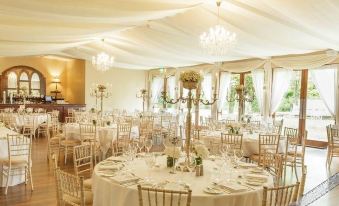 a beautifully decorated dining room with tables covered in white tablecloths and chairs arranged around them at Bellinter House