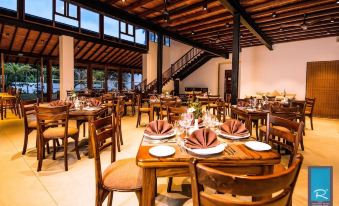 a large dining room with wooden tables and chairs , plates , and cutlery set for a meal at R Degrees