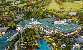 aerial view of a large resort with multiple buildings , a pool , and lush greenery surrounding it at Four Seasons Resort Nevis