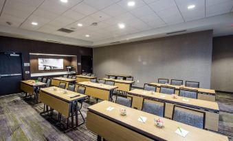 a large conference room with rows of chairs arranged in a semicircle , and a podium at the front of the room at Courtyard Columbia Cayce