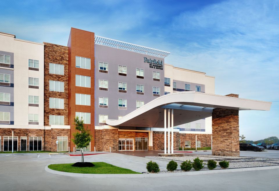 "a large brick hotel with a white canopy and the words "" hilton garden inn "" on it" at Fairfield Inn & Suites Houston League City