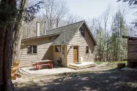 Centrally located cozy cottage tucked into the woods, a perfect family retreat