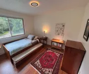 Private mid-century modern hideaway in forest near the river and sea.