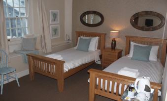 a hotel room with two twin beds , one on the left side and the other on the right side of the room at Halfway House Inn