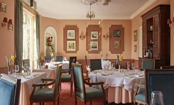 a dining room with tables and chairs arranged for a group of people to enjoy a meal together at Corse Lawn House Hotel