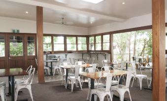 a dining room with tables and chairs arranged for a group of people to enjoy a meal together at Ulmarra Hotel