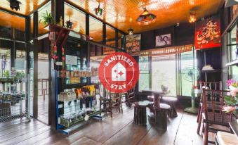 "a restaurant with a red sign that says "" sanitized stay "" and a red umbrella above the entrance" at Phufatara Resort