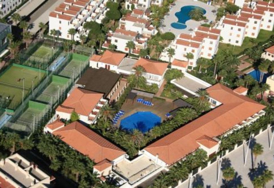 an aerial view of a residential area with multiple houses and a swimming pool surrounded by greenery at Estival Park Silmar