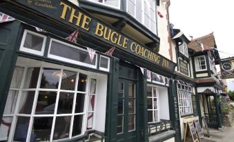 the bugle coaching inn with its sign , as well as several other businesses in the town at The Bugle Coaching Inn