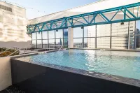 Cozy Retreat with Rooftop Pool, Parking, and Spacious Comfort