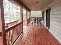 Three bedroom hide-a-way with spacious deck over looking Island Lake.