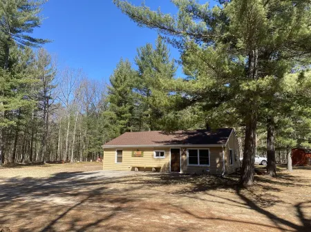 Rustic home on wooded lot, very private. Lake and dock access. Close to trails.