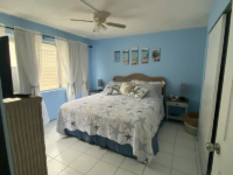 Tropical one bedroom condo steps from pool.