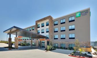 a holiday inn express hotel with its large windows and a stone facade , under a clear blue sky at Home2 Suites by Hilton Fort Worth  Northlake