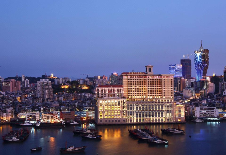 The city's skyline and buildings are illuminated in various colors at night at Sofitel Macau at Sofitel Macau at Ponte 16