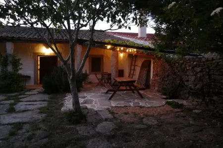 Stone house with garden, barbecue and fireplace.