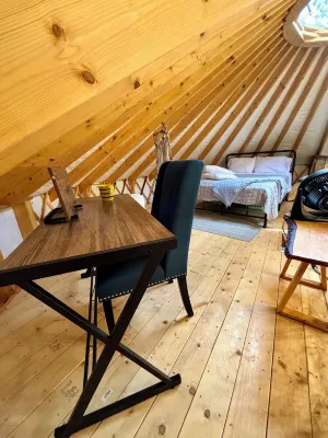 Elevated eclectic yurt with wrap-around porch, hot tub, and mountain view!