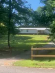 Surrounded by sweetgum and maple trees, this house is perfect for some R & R.