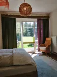 Spacious vacation apartment with fireplace and barrel sauna in the sheltered garden.