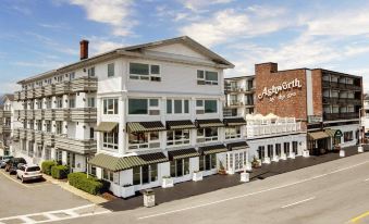 "a large white building with a sign that reads "" ashworth inn "" is shown on a street corner" at Ashworth by the Sea