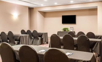 a conference room set up for a meeting with several chairs arranged in rows and a tv mounted on the wall at Comfort Inn Largo-Washington DC East