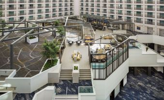 a modern office building with an atrium , where people are working and interacting with each other at Hyatt Regency San Francisco Airport