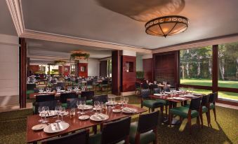 a large , well - lit dining room with multiple tables and chairs arranged for a formal event at Lisbon Marriott Hotel