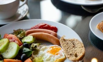 a plate of food on a dining table , including a variety of breakfast items such as eggs , toast , and fruit at Homewood Suites by Hilton Aliso Viejo Laguna Beach