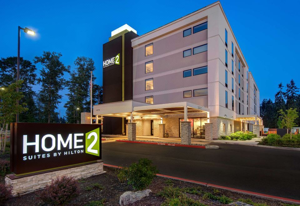 "a large hotel with a sign that says "" home 2 "" in front of it , and a road leading up to it" at Home2 Suites by Hilton Marysville