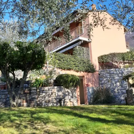 Apartment Agnese with lake view, swimming pool, garage and private garden.