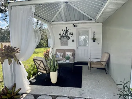 Modern studio apartment with covered outside seating area