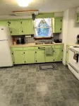 Beautiful cabin situated on wooded land with nice yard clearing and small stream