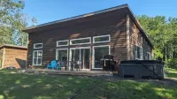 Unwind at BasinView Retreat: Luxe Waterfront Cottage with hot tub & beach access