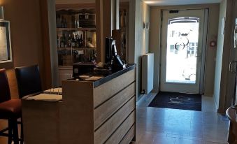 a wooden reception desk in a dimly lit room with a door at the end at La Cote d'Or