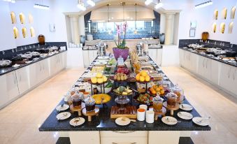 a buffet table filled with a variety of food items , including fruits , vegetables , and desserts at Le Royal Hotel - Beirut