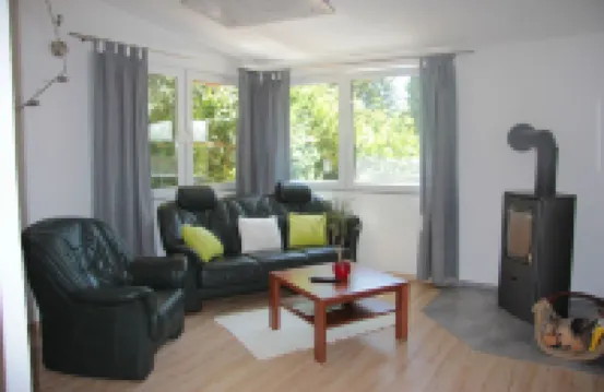 Modernly Furnished Bungalow with Fireplace, Surrounded by Greenery.