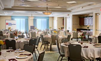 a large dining room filled with tables and chairs , ready for a group of people to enjoy a meal together at Hilton Garden Inn Merrillville