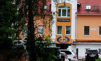 "a brick building with a sign that reads "" cospubla "" on it , surrounded by trees and parked cars" at VIP Hotel