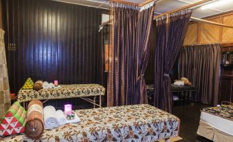a massage room with two massage tables , one on the left and one on the right , covered with blankets at Mutiara Taman Negara