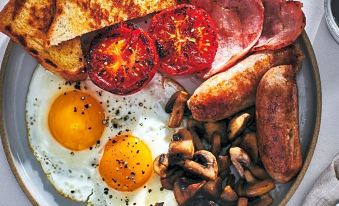 a large plate filled with a variety of food items , including eggs , ham , and mushrooms at The Anchorage Hotel