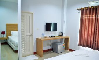 a small hotel room with a bed , a tv , a desk , a chair , and a microwave at Pool House Lanska