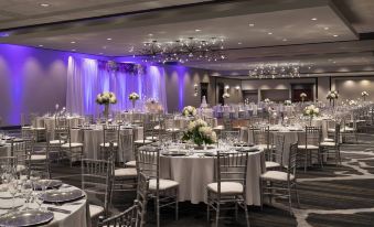 a large banquet hall with numerous tables and chairs set up for a formal event at Cleveland Marriott East