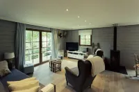 Scandinavian chalet in lush greenery and forest ...