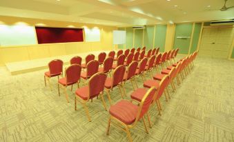 a conference room with rows of red chairs arranged in a semicircle , ready for a meeting at Summer Bay Resort, Lang Tengah Island